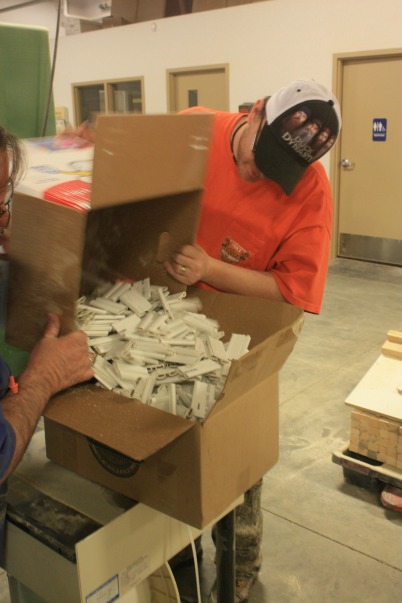 COR Enterprises worker loads markers into boxes. (photo, Bruce Waage)
