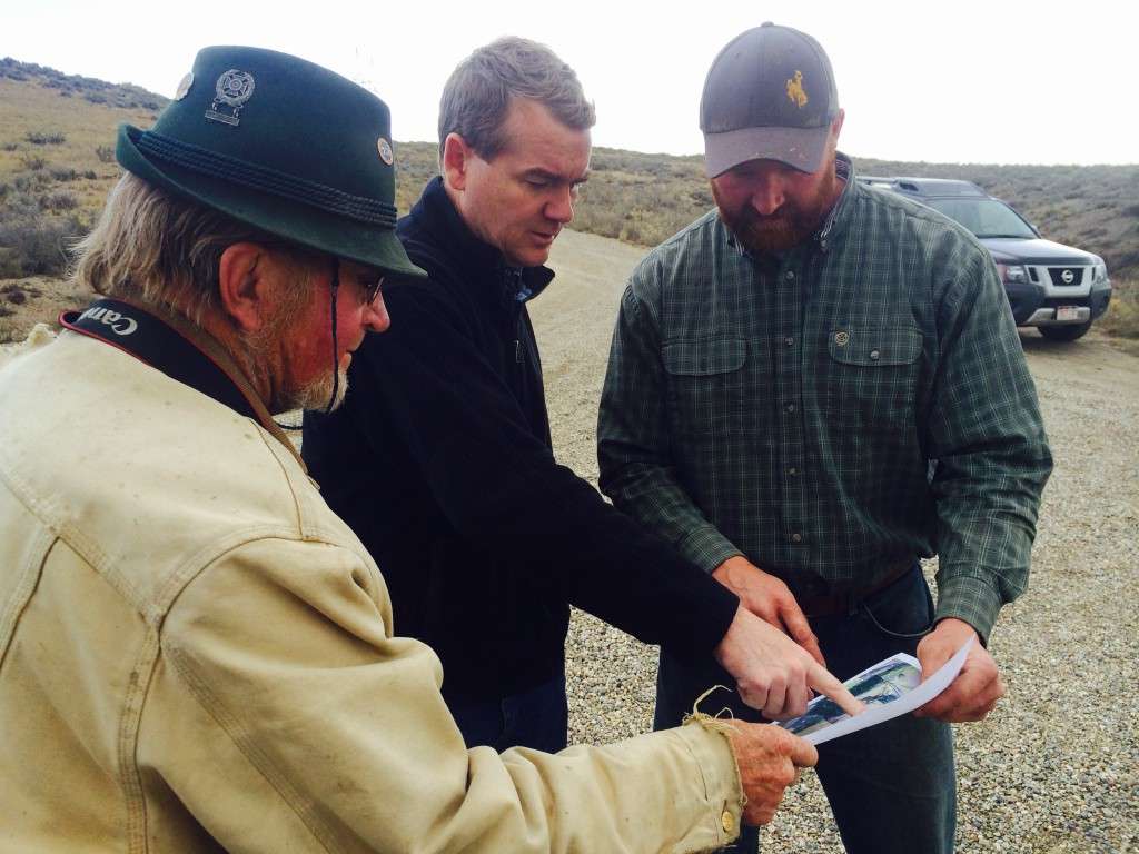 Senator Bennet (CO) looks at map of Yust property with Jim Yust (left) and son Jay Yust (right) CCALT photo.