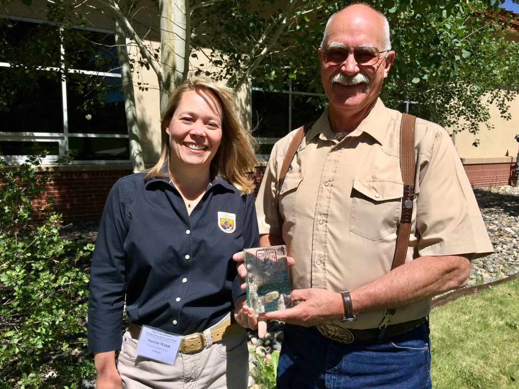 Noreen Walsh, USFWS Mountain Prairie Region Director, presents the "Recovery Champion Award" to Gunnison rancher and biologist Jim Cochran at the SGI workshop. Jim Cochran is a leader in sage grouse conservation efforts.